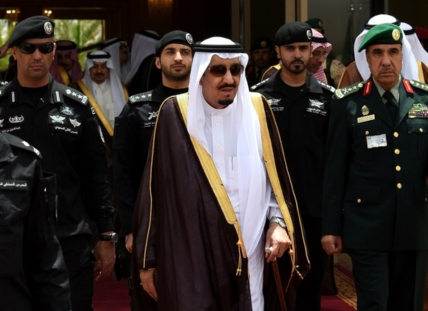 Deep-rooted structural realities means that Saudi Arabia is indeed on the brink of protracted state-failure, a process likely to take-off in the next few years. Saudi King Salman bin Abdulaziz (C) walks surrounded by security officers to receive Bahraini King Hamad bin Isa al-Khalifa (unseen) upon the latter's arrival in Riyadh to attend the Gulf Cooperation Council (GCC) summit on May 5, 2015. AFP PHOTO / FAYEZ NURELDINE