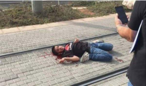 Ahmad Manasra, a 13-year-old Palestinian boy, lying on the ground, bleeding from multiple gunshot wounds