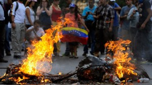 Fires are started during the protests. Maduro won by an estimated 300,000 votes. It is the second election Capriles has lost in under a year.(AFP Photo / Leo Ramirez)