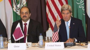 Qatari Foreign Minister Khalid Bin al Attiyah and US Secretary of State Kerry pose prior to meeting with the Arab League in Paris