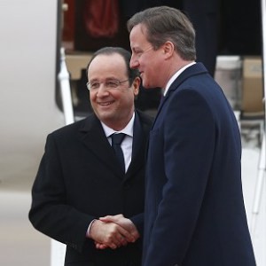 Prime Minister David Cameron greets France's President Francois Hollande at RAF Brize Norton.