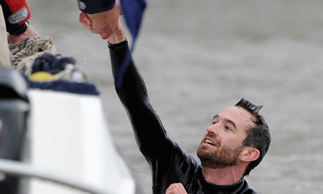 Trenton Oldfield is helped from the waters of the Thames after jumping in front of the boats in the 2012 Boat Race in protest against elitism and government cuts. Photograph: Paul Hackett/Reuters