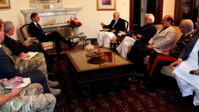 Afghan President Hamid Karzai meets with British Defence Secretary Philip Hammond in Kabul. (file photo)