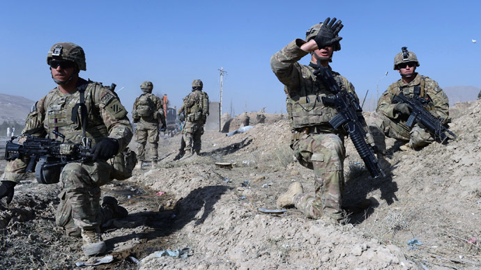 US soldiers stand guard near the site of a suicide attack in Maidan Shar, the capital city of Wardak province south of Kabul on September 8, 2013. (AFP Photo/Shah Marai)