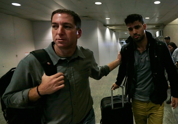 Glenn Greenwald walks with his partner David Miranda in Rio de Janeiro's International Airport. Reuters/Ricardo Morales/